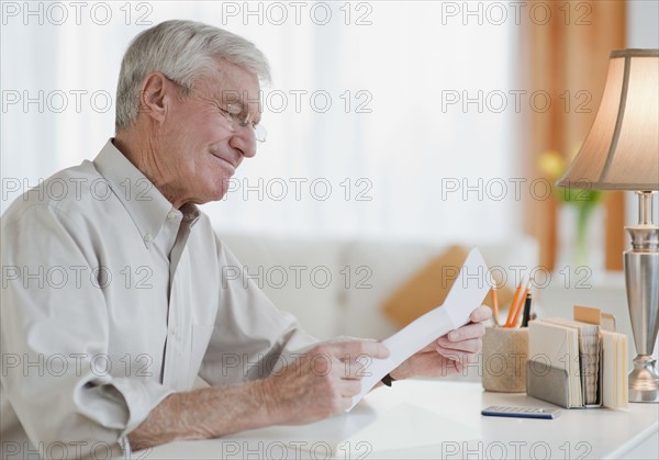 Senior man reading letter.