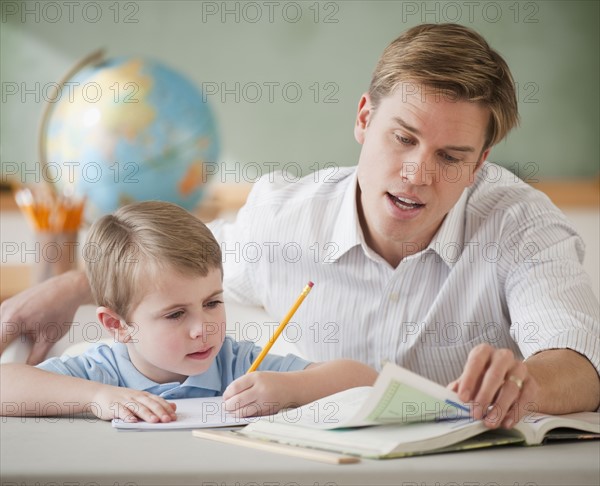 Teacher helping student with homework.