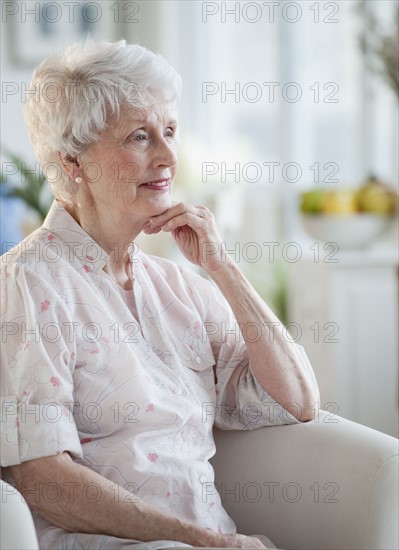 Senior woman sitting on sofa.