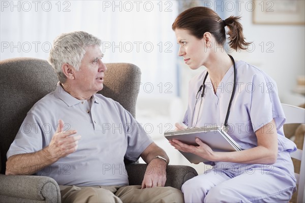 Nurse talking to senior man.