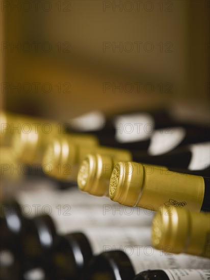 Close up of wine bottle tops.