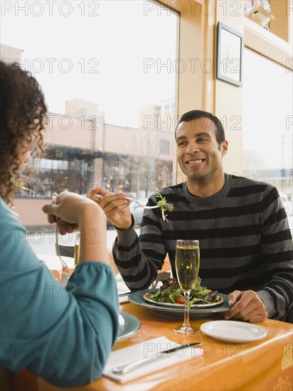 Couple eating in restaurant.