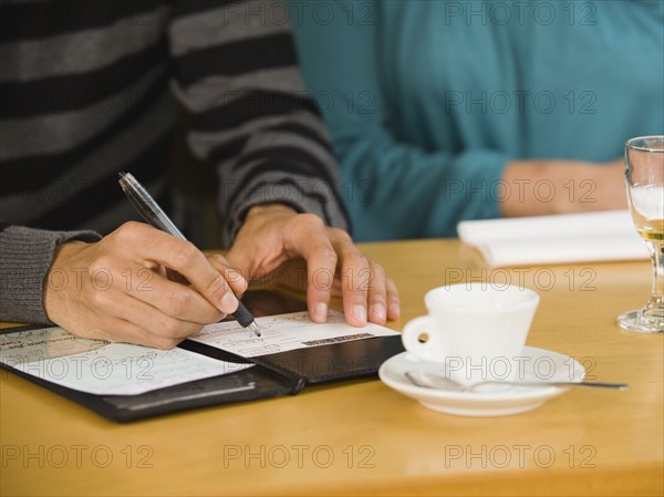 Man paying restaurant bill.