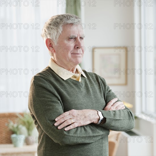 Senior man with arms crossed.