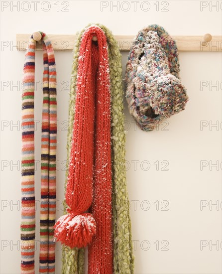 Snowy scarves hanging on rack. Photographe : Jamie Grill