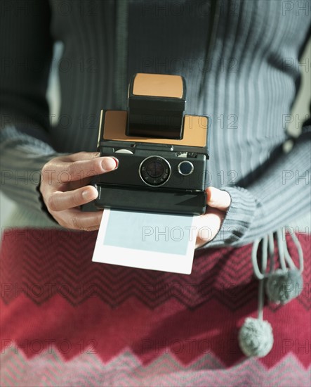 Woman holding vintage camera.