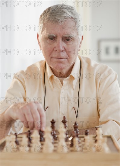 Senior man playing chess.