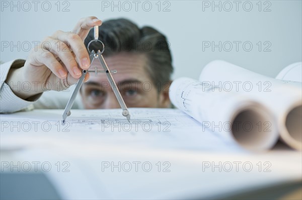 Architect using drawing compass.