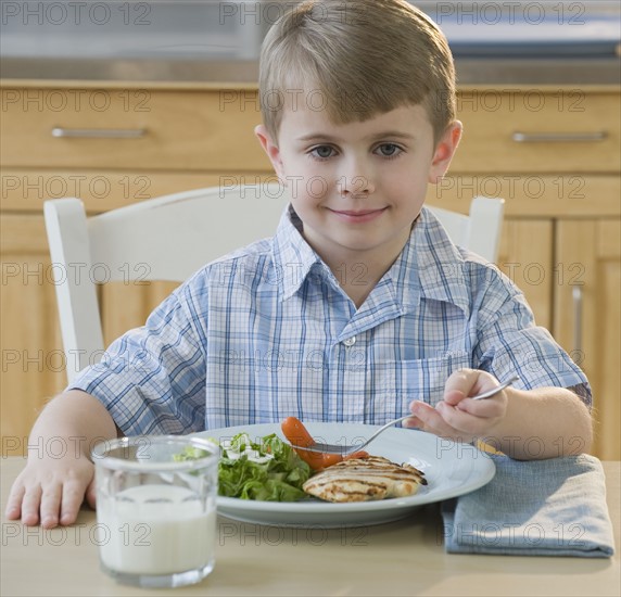 Boy eating dinner.