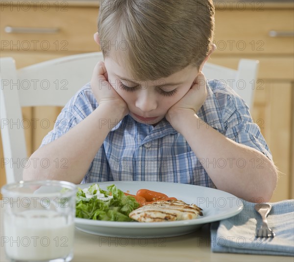 Boy looking at dinner.