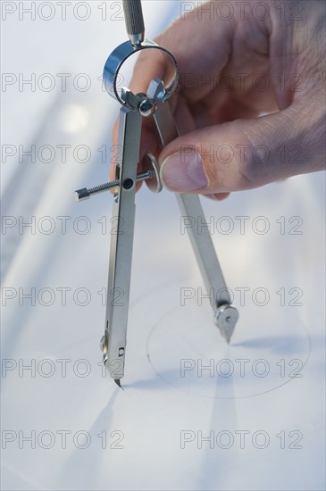 Man using drawing compass.