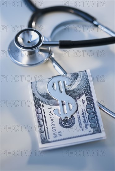 Money in clip and stethoscope.