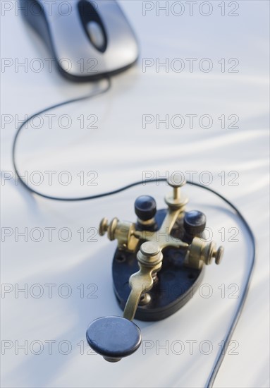 Antique telegraph key and computer mouse.