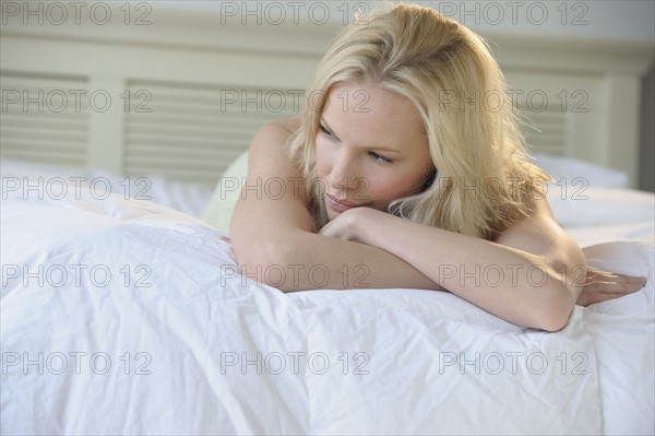 Woman relaxing on bed.