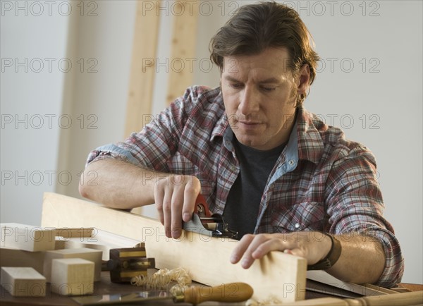 Man using woodworking tools.