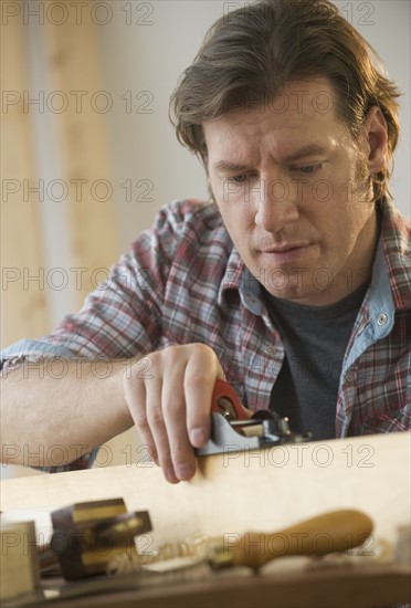 Man using woodworking tools.