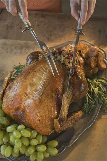 Man carving Thanksgiving turkey.