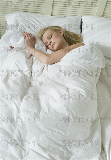 Woman sleeping in bed.