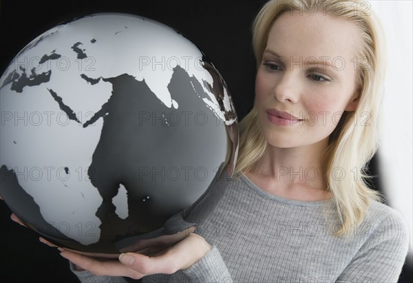 Woman holding modern globe.