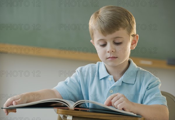 Boy reading book.