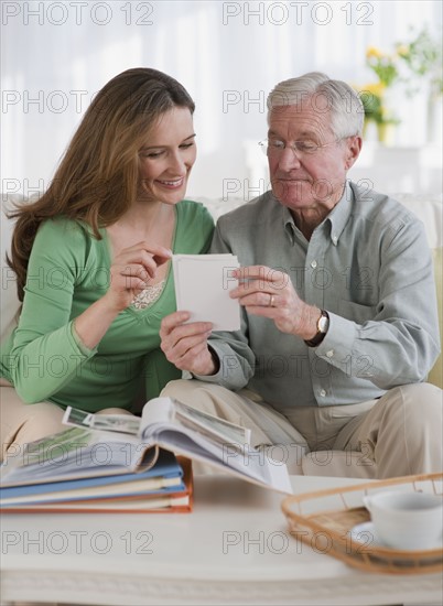 Father an daughter looking at photo albums.