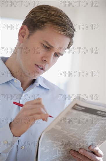 Man reading job listings.
