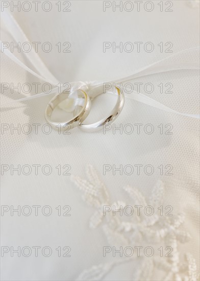 Close up of wedding rings on pillow. Photographe : Jamie Grill