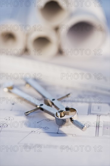 Drawing compass and blueprints. Photographe : Daniel Grill