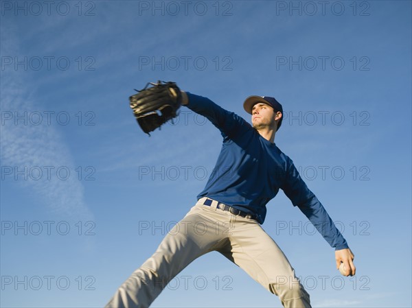 Baseball player throwing ball.