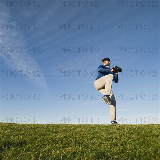 Baseball player throwing ball.