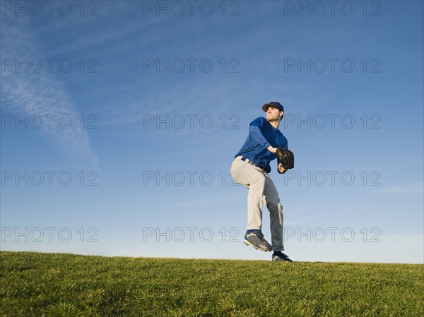 Baseball player throwing ball.