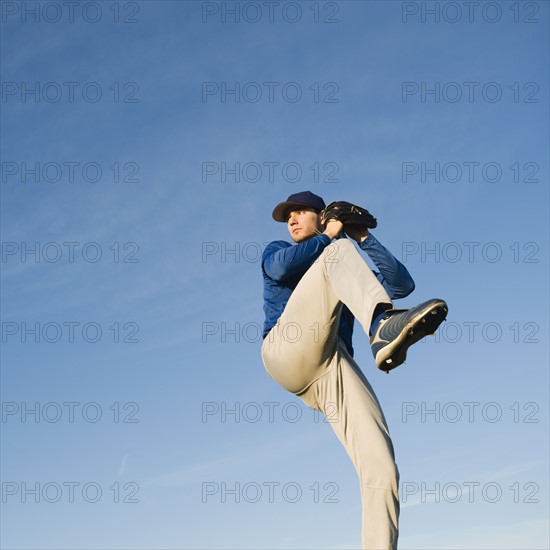 Baseball player throwing ball.