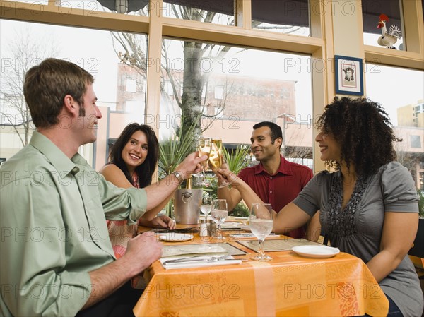 Friends toasting in restaurant.