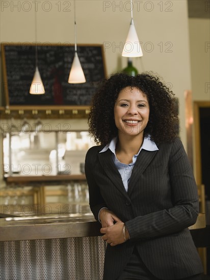 Businesswoman posing in restaurant.