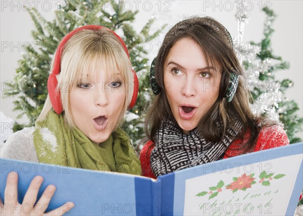 Women singing Christmas carols. Photographe : Jamie Grill