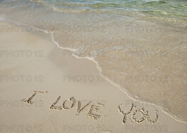 I love you message written in sand.