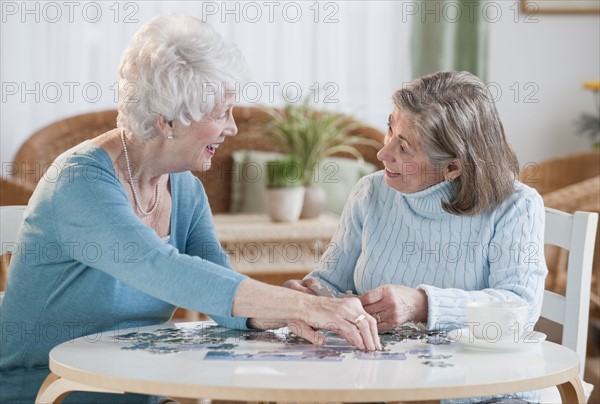 Senior women assembling puzzle.