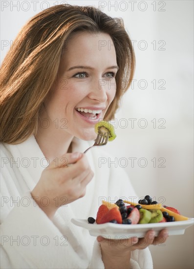 Woman eating fresh fruit.