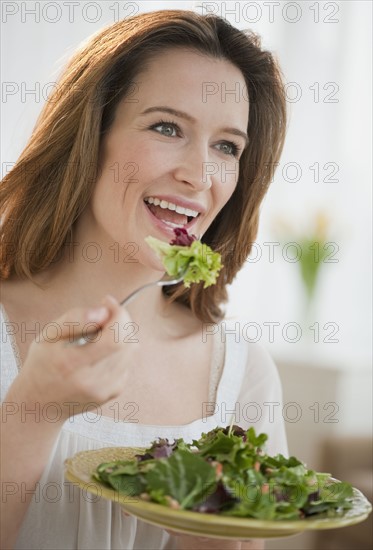 Woman eating salad.