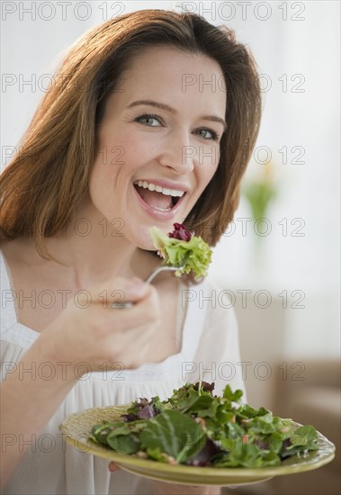 Woman eating salad.