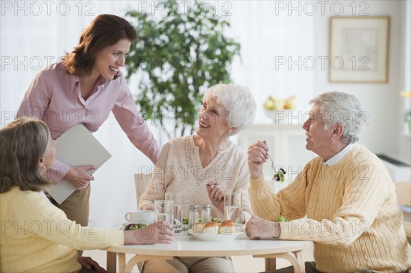 Senior adults eating dinner.