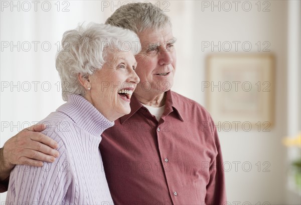 Senior couple hugging.