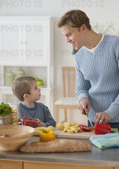 Father and son cooking dinner.