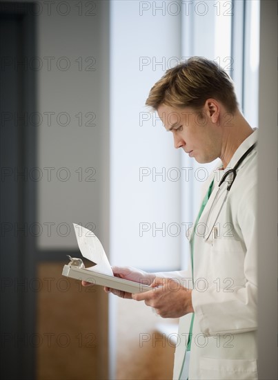 Doctor reading medical chart.