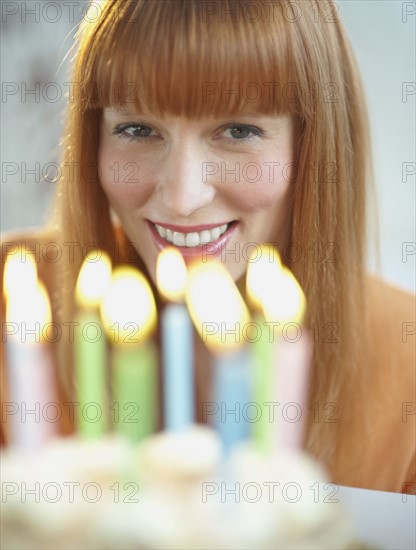 Woman celebrating birthday with cake.