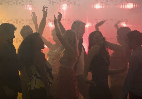 People dancing in nightclub.
