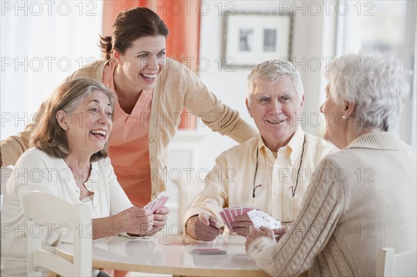 Senior adults playing cards.