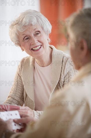 Senior adults playing cards.