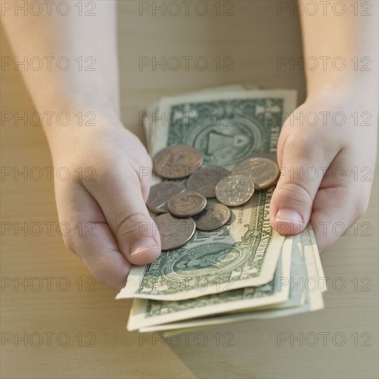 Boy holding money.
