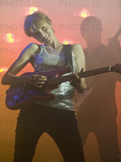 Performers playing electric guitars.